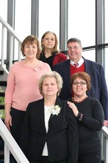 Paul Avery on the stairs in the lobby of Trans-Overseas. Paul is on the center right and clockwise from him is Linda Thompson, Carrol Brandes, Mary, and Linda Redding.