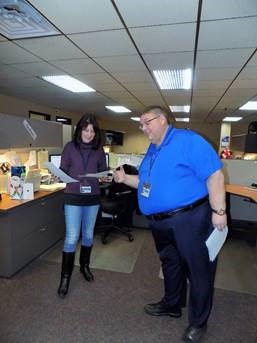 Paul Avery in the Trans-Overseas offices discussing a document with Andrea Blasengym.